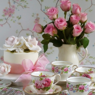 Photograph: roses, cups, and a cake.